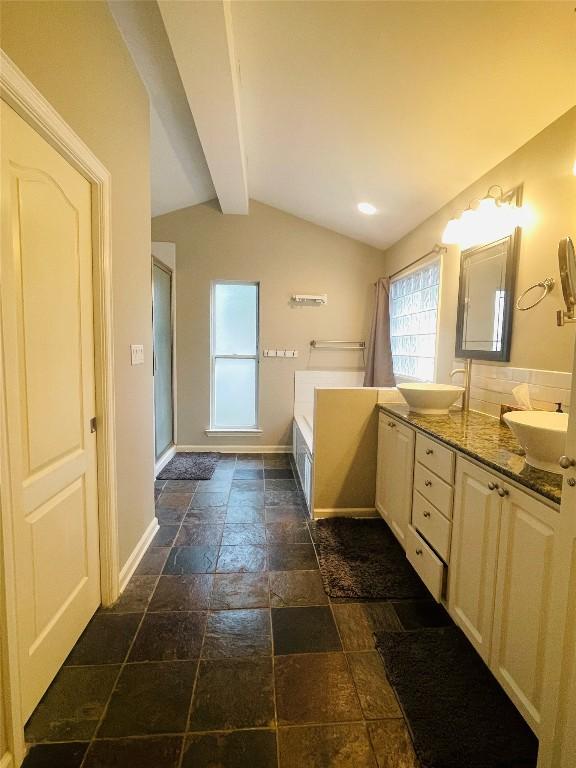 2003 Woodmont Ave, Austin, TX 78703 - bathroom with stone tile flooring, double vanity, and a garden tub
