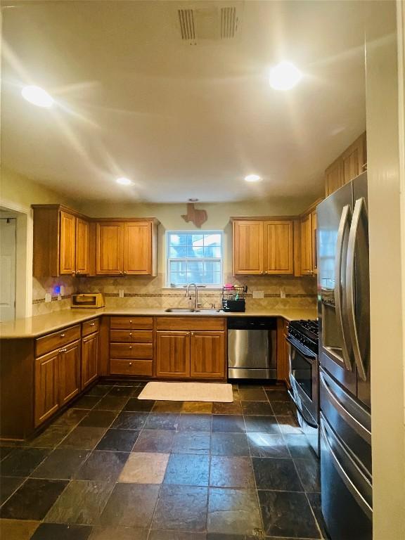 2003 Woodmont Ave, Austin, TX 78703 - kitchen with stainless steel appliances, light countertops, decorative backsplash, and recessed lighting