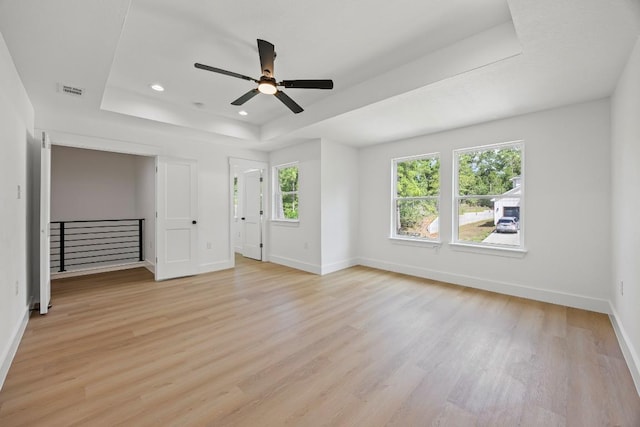 161 Honopu Dr, Bastrop, TX 78602 - unfurnished room with a raised ceiling, light wood-style flooring, a ceiling fan, and recessed lighting