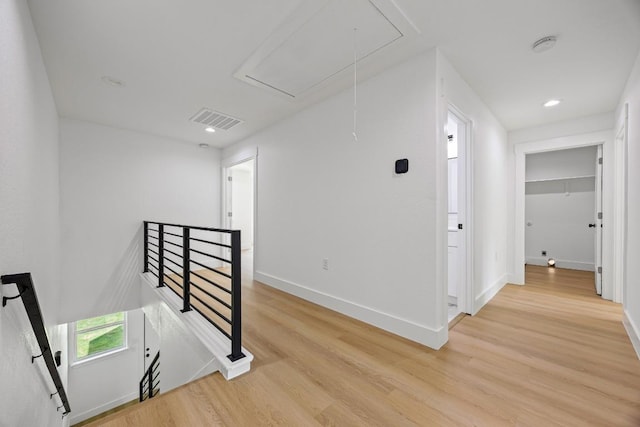 161 Honopu Dr, Bastrop, TX 78602 - hallway featuring attic access, an upstairs landing, light wood-style flooring, and recessed lighting