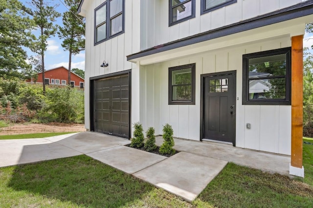 161 Honopu Dr, Bastrop, TX 78602 - property entrance featuring an attached garage and board and batten siding
