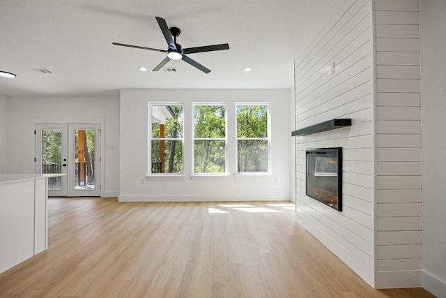 161 Honopu Dr, Bastrop, TX 78602 - unfurnished living room with light wood-style floors, a large fireplace, ceiling fan, and recessed lighting