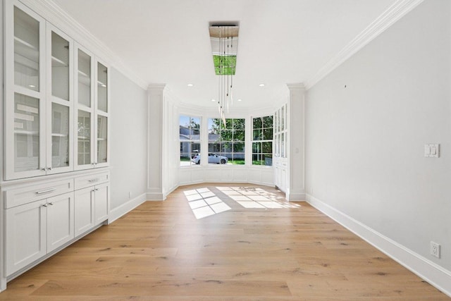5 Green Ln, Austin, TX 78703 - unfurnished dining area featuring crown molding, recessed lighting, and light wood-style floors