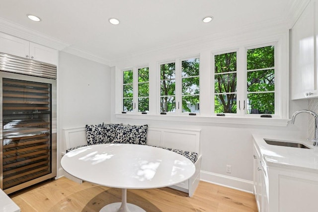 5 Green Ln, Austin, TX 78703 - dining space with beverage cooler, plenty of natural light, light wood-type flooring, crown molding, and recessed lighting