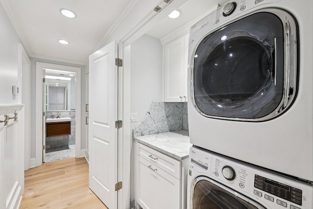 5 Green Ln, Austin, TX 78703 - laundry room with stacked washer / drying machine, light wood-style flooring, and recessed lighting
