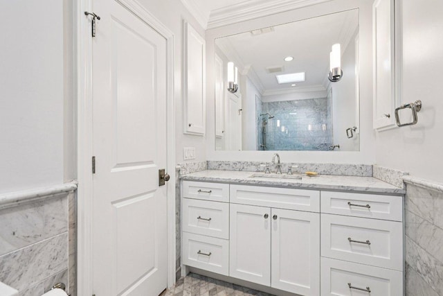 5 Green Ln, Austin, TX 78703 - bathroom featuring ornamental molding, tile walls, vanity, a stall shower, and wainscoting