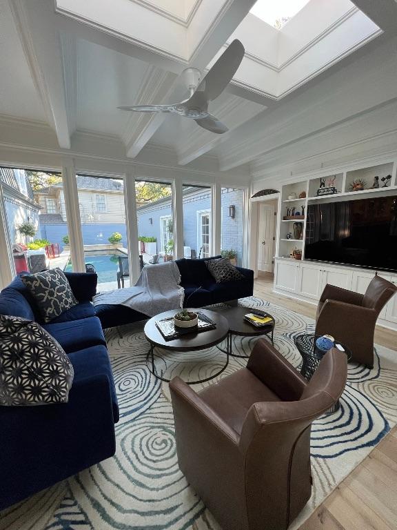 5 Green Ln, Austin, TX 78703 - sunroom with beam ceiling, wood finished floors, a skylight, and ornamental molding