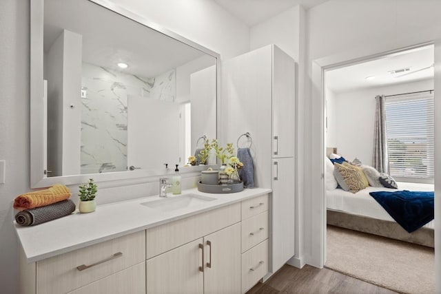 6324 N Lamar Blvd Unit 216, Austin, TX 78752 - ensuite bathroom with vanity, wood finished floors, and a marble finish shower