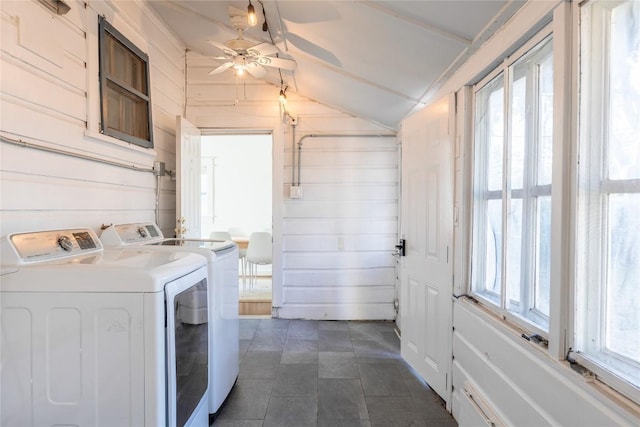 1028 E 43rd St, Austin, TX 78751 - laundry room with washer and clothes dryer, ceiling fan, wood walls, and dark tile patterned flooring