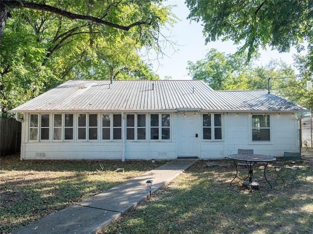 1028 E 43rd St, Austin, TX 78751 - rear view of house with a metal roof and crawl space