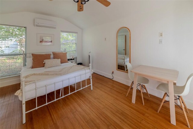 1028 E 43rd St, Austin, TX 78751 - bedroom featuring an AC wall unit, lofted ceiling, light wood-type flooring, and ceiling fan