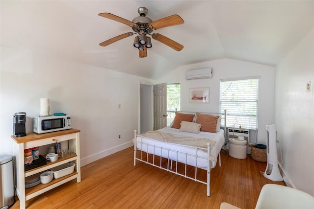 1028 E 43rd St, Austin, TX 78751 - bedroom with a wall unit AC, lofted ceiling, wood finished floors, and a ceiling fan