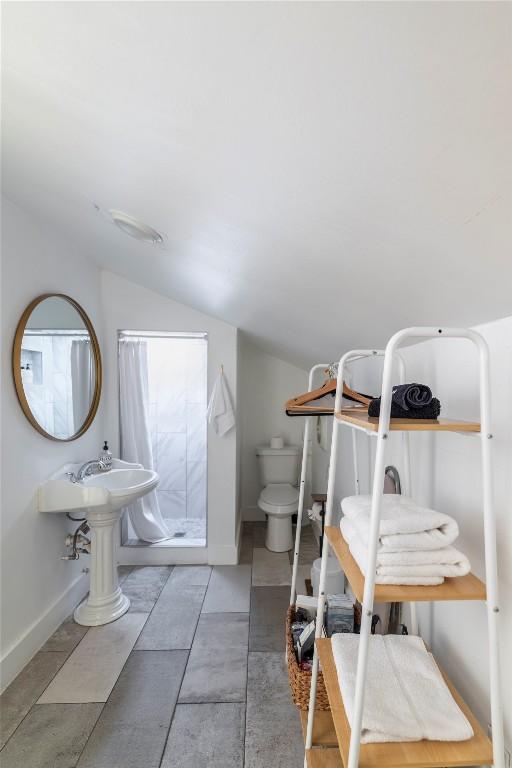 1028 E 43rd St, Austin, TX 78751 - full bathroom with vaulted ceiling and a stall shower