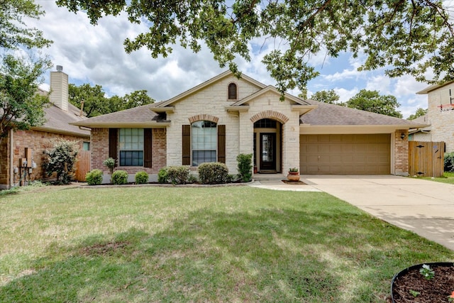 11125 Cap Stone Dr, Austin, TX 78739 - french country home with a garage, concrete driveway, roof with shingles, stone siding, and brick siding