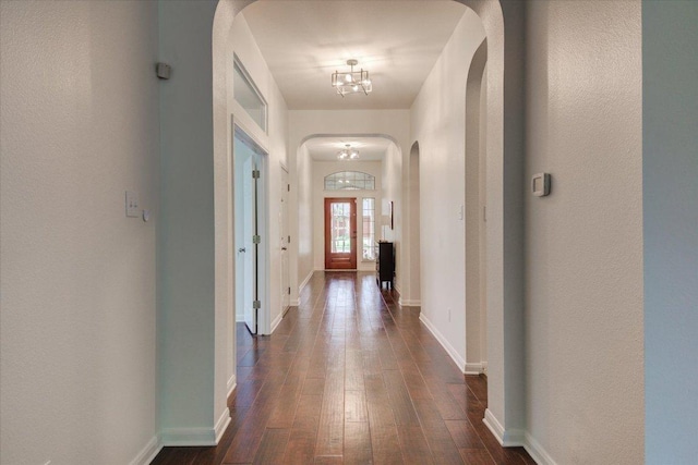 11125 Cap Stone Dr, Austin, TX 78739 - hallway with arched walkways, dark wood-type flooring, and a chandelier