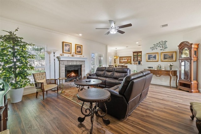 1004 Oaklands Dr, Round Rock, TX 78681 - living room featuring a ceiling fan, ornamental molding, wood finished floors, and a fireplace