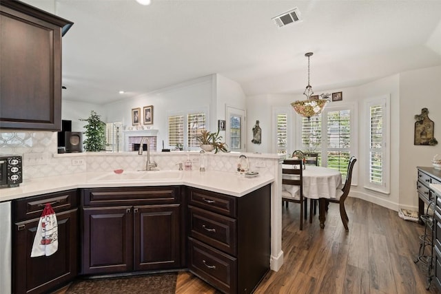1004 Oaklands Dr, Round Rock, TX 78681 - kitchen featuring a peninsula, decorative backsplash, dark wood finished floors, and recessed lighting