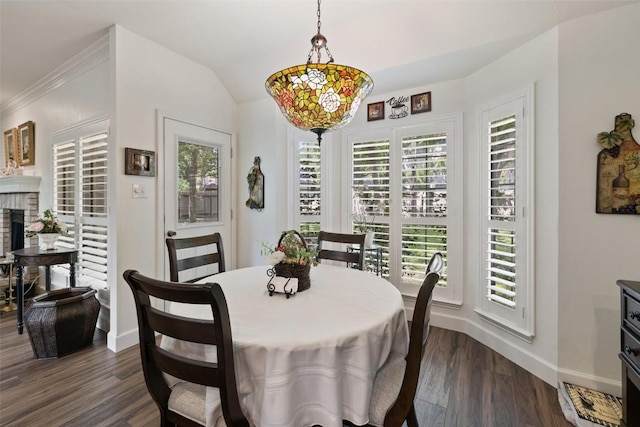 1004 Oaklands Dr, Round Rock, TX 78681 - dining space with healthy amount of natural light, dark wood-style flooring, and a brick fireplace