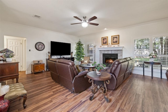 1004 Oaklands Dr, Round Rock, TX 78681 - living area with ceiling fan, ornamental molding, wood finished floors, and a brick fireplace