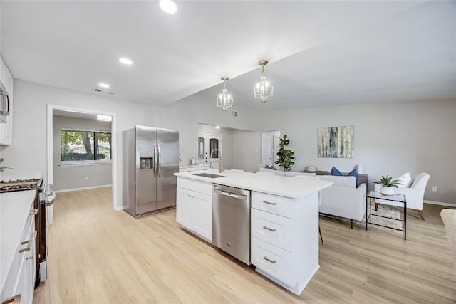 11309 Timbrook Trl, Austin, TX 78750 - kitchen featuring appliances with stainless steel finishes, white cabinetry, light wood-style flooring, light countertops, and recessed lighting