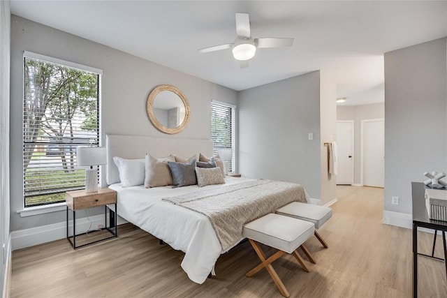 11309 Timbrook Trl, Austin, TX 78750 - bedroom featuring multiple windows, light wood-style flooring, and a ceiling fan