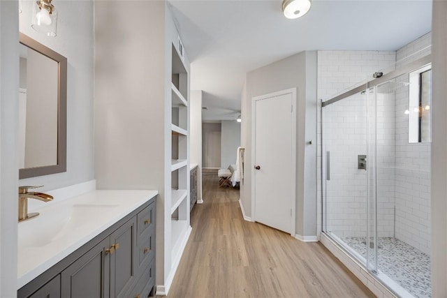 11309 Timbrook Trl, Austin, TX 78750 - bathroom with vanity, wood finished floors, and a stall shower