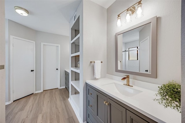 11309 Timbrook Trl, Austin, TX 78750 - full bath with wood finished floors, vanity, and a shower