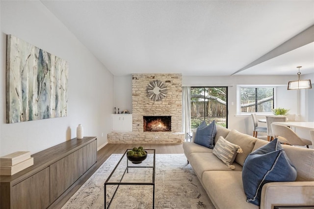 11309 Timbrook Trl, Austin, TX 78750 - living area with wood finished floors, a stone fireplace, and vaulted ceiling