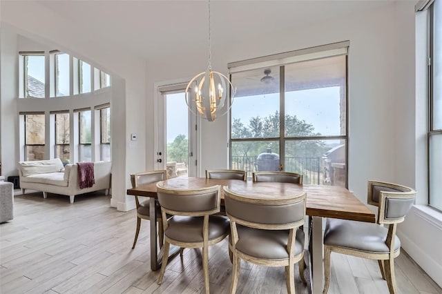 217 Emerald Ridge Dr, Austin, TX 78732 - dining area with a chandelier and light wood finished floors