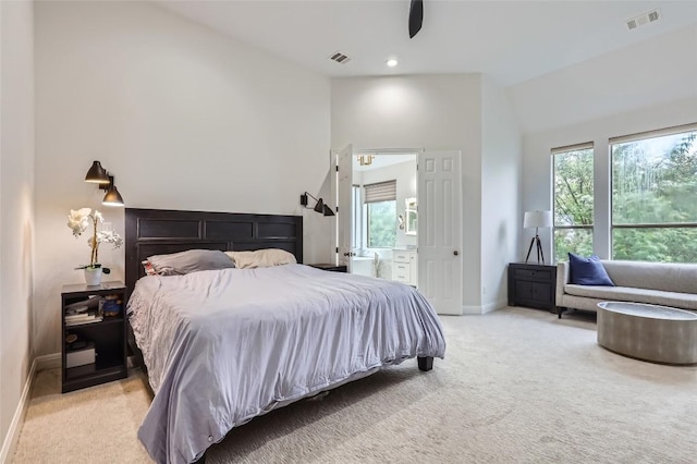 217 Emerald Ridge Dr, Austin, TX 78732 - bedroom with light carpet, vaulted ceiling, ensuite bathroom, recessed lighting, and a ceiling fan