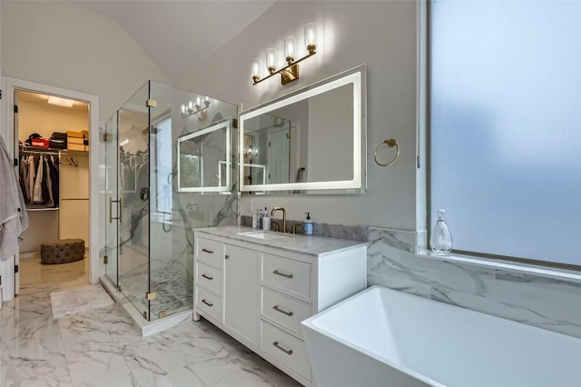 217 Emerald Ridge Dr, Austin, TX 78732 - full bathroom featuring marble finish floors, a marble finish shower, a soaking tub, a spacious closet, and vanity