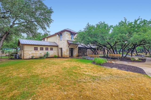 217 Emerald Ridge Dr, Austin, TX 78732 - back of house with stone siding, a standing seam roof, and a metal roof