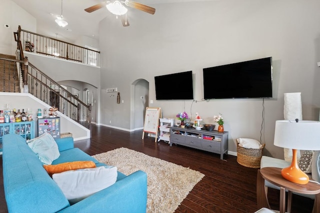 137 Paul Azinger Dr, Round Rock, TX 78664 - living room featuring arched walkways, ceiling fan, wood finished floors, a high ceiling, and stairs