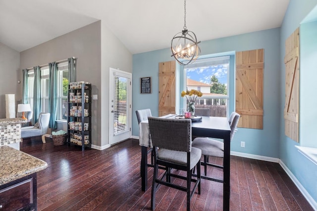 137 Paul Azinger Dr, Round Rock, TX 78664 - dining space featuring a chandelier, dark wood finished floors, and vaulted ceiling