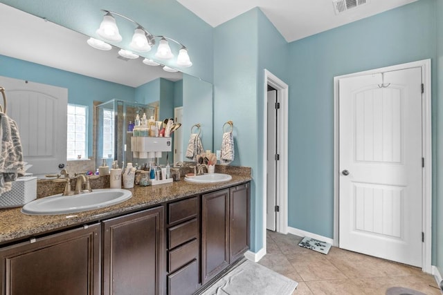 137 Paul Azinger Dr, Round Rock, TX 78664 - bathroom featuring a stall shower, double vanity, and tile patterned flooring