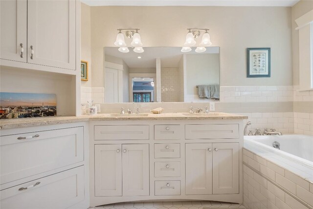 903 E 14th St, Austin, TX 78702 - bathroom with double vanity, a bath, and tile patterned flooring