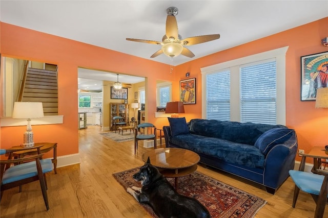 903 E 14th St, Austin, TX 78702 - living room featuring ceiling fan, light wood-type flooring, and stairway