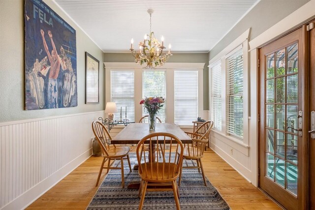 903 E 14th St, Austin, TX 78702 - dining room with a chandelier, light wood-style flooring, plenty of natural light, a wainscoted wall, and ornamental molding