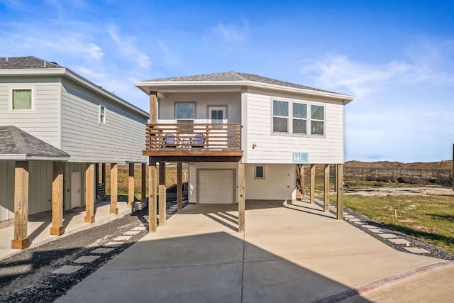 162 La Concha Blvd Unit 10, Port Aransas, TX 78373 - view of front of property featuring a carport, an attached garage, concrete driveway, and a balcony
