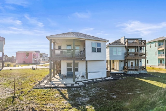 162 La Concha Blvd Unit 10, Port Aransas, TX 78373 - rear view of property with a balcony, a patio, a yard, and a residential view