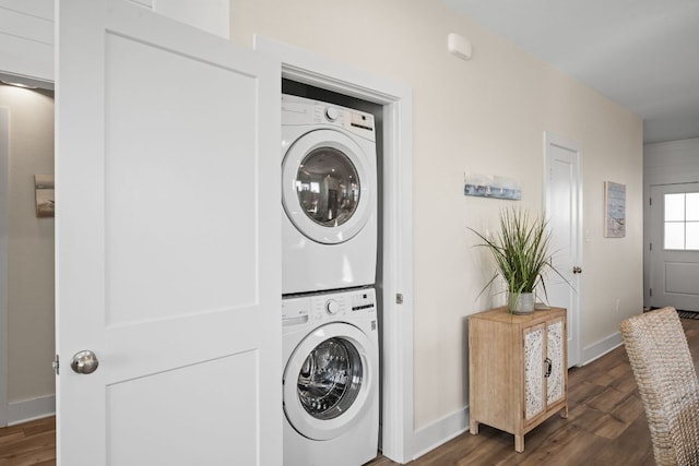 162 La Concha Blvd Unit 10, Port Aransas, TX 78373 - washroom with stacked washer and clothes dryer and dark wood-type flooring