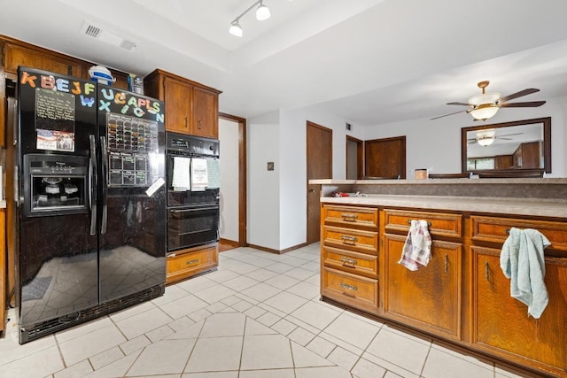 1303 Creekview Dr, Round Rock, TX 78681 - kitchen with black appliances, light tile patterned flooring, brown cabinets, and ceiling fan