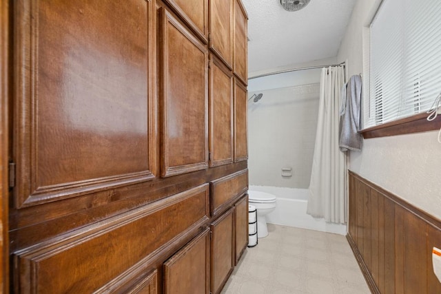1303 Creekview Dr, Round Rock, TX 78681 - bathroom featuring shower / bathtub combination with curtain, tile patterned floors, wainscoting, and wooden walls