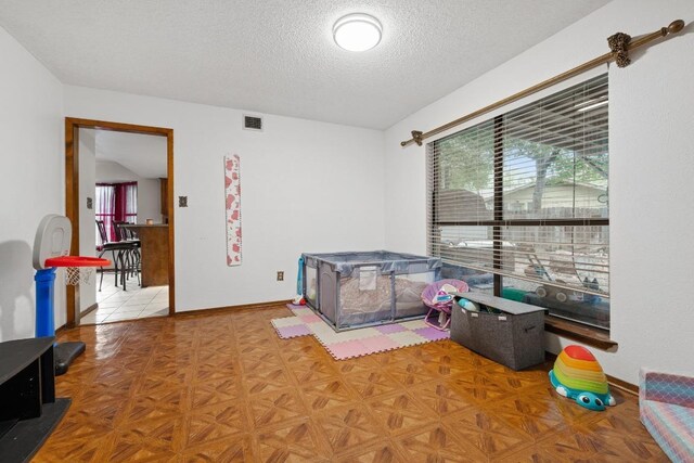 1303 Creekview Dr, Round Rock, TX 78681 - bedroom featuring a textured ceiling and baseboards