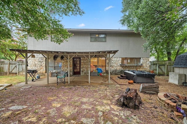 1303 Creekview Dr, Round Rock, TX 78681 - rear view of property featuring a fire pit, stone siding, a patio area, and a fenced backyard