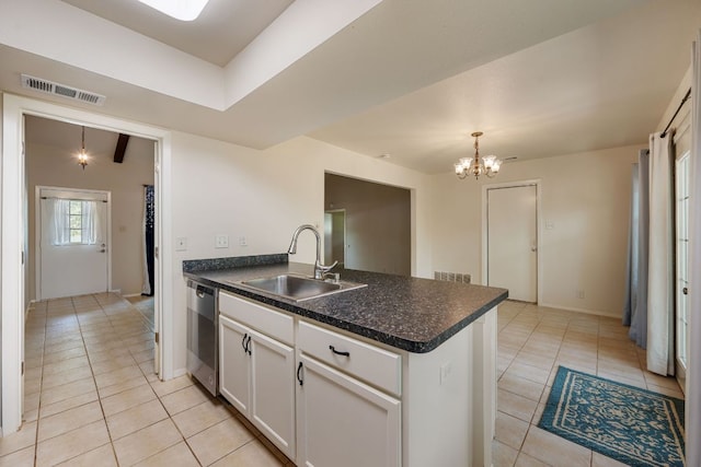 236 Lodestone Cir, Cedar Park, TX 78613 - kitchen with a peninsula, stainless steel dishwasher, light tile patterned flooring, and a chandelier