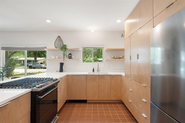 5507 Duval St Unit A, Austin, TX 78751 - kitchen featuring appliances with stainless steel finishes, open shelves, light countertops, light brown cabinets, and recessed lighting