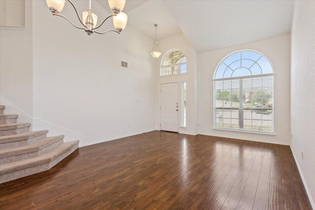 3211 Malmaison Rd, Killeen, TX 76542 - entrance foyer with a chandelier, dark wood-type flooring, stairway, and high vaulted ceiling