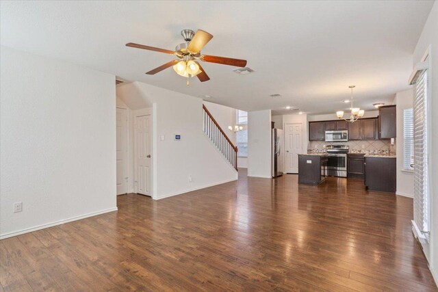 3211 Malmaison Rd, Killeen, TX 76542 - unfurnished living room with a chandelier, dark wood-style flooring, ceiling fan, and stairs