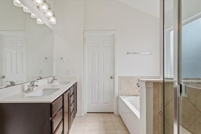 3211 Malmaison Rd, Killeen, TX 76542 - bathroom featuring a garden tub, double vanity, tile patterned flooring, lofted ceiling, and a stall shower